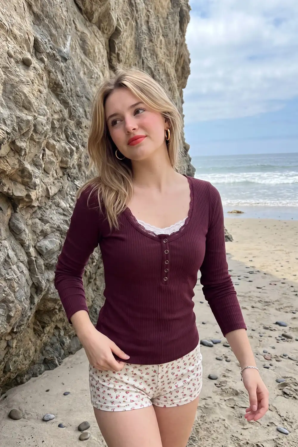 Woman in dark burgundy ribbed lace trim henley top with white floral print mini shorts