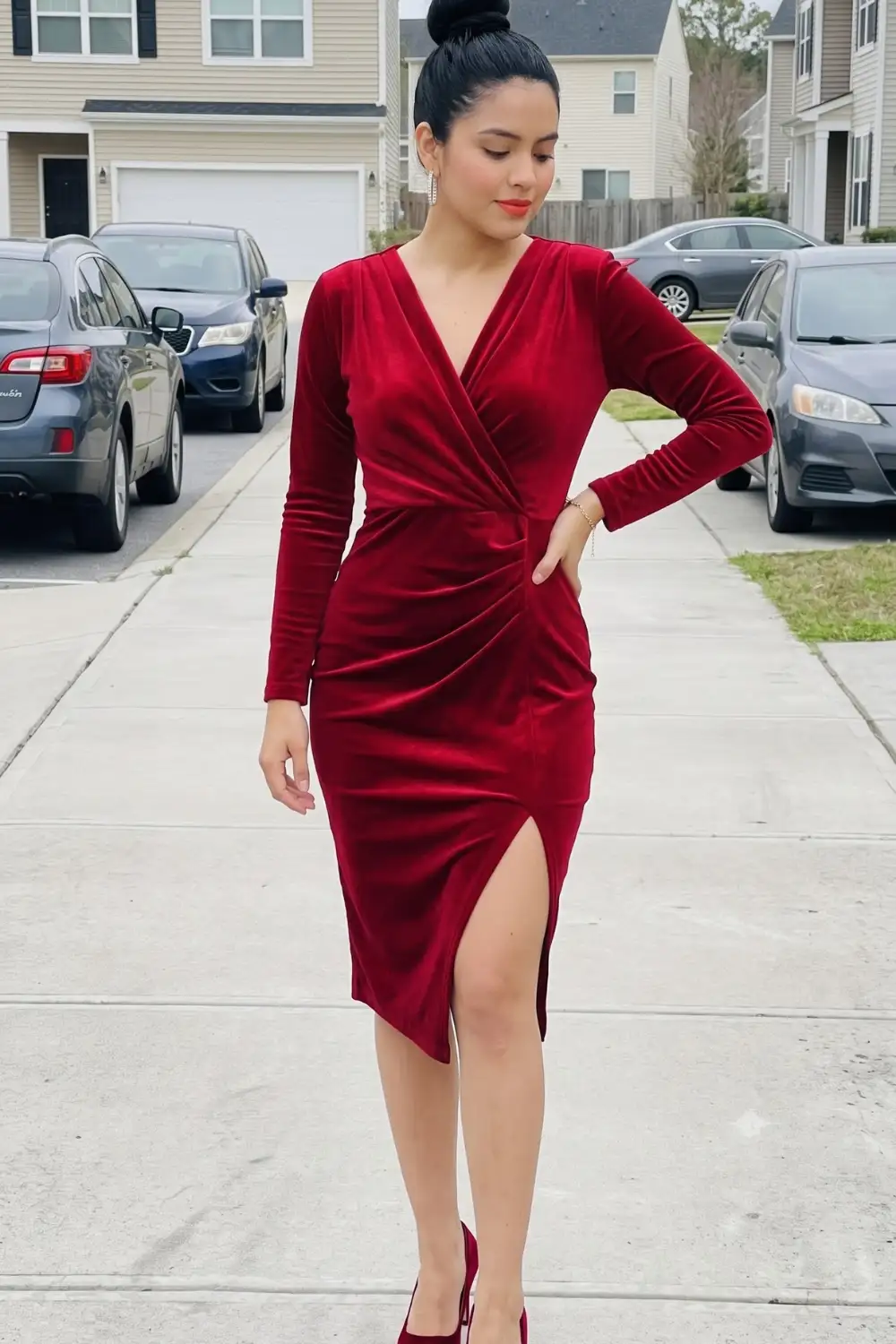 Woman in dark red velvet long sleeve wrap v-neck ruched asymmetric hem midi dress with red heels