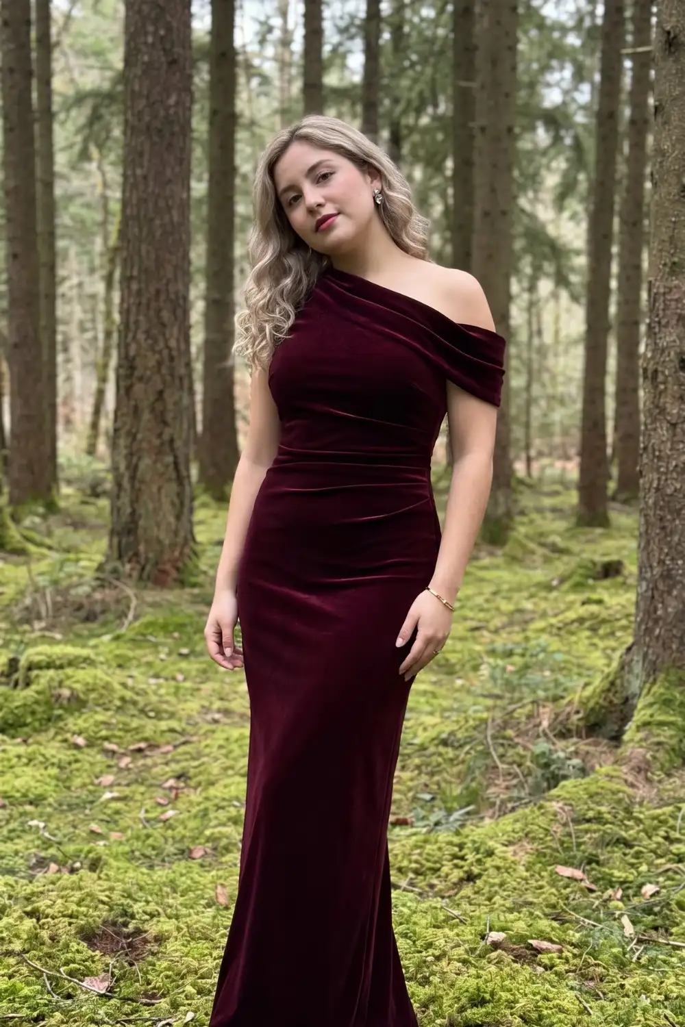 Woman in burgundy velvet one shoulder off shoulder ruched fitted maxi dress