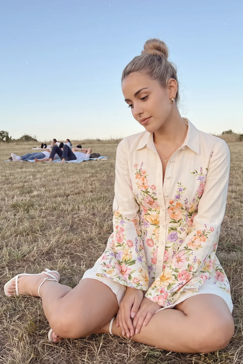 Woman in cream floral print button down shirt mini dress