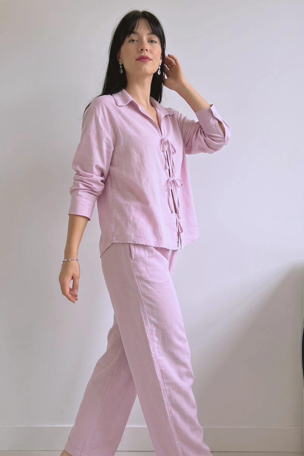 Woman in lilac pink linen tie front long sleeve shirt and wide leg pants pajama set