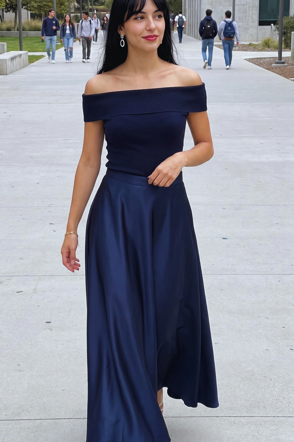 Woman in navy blue off shoulder ribbed top with navy blue satin flared maxi skirt
