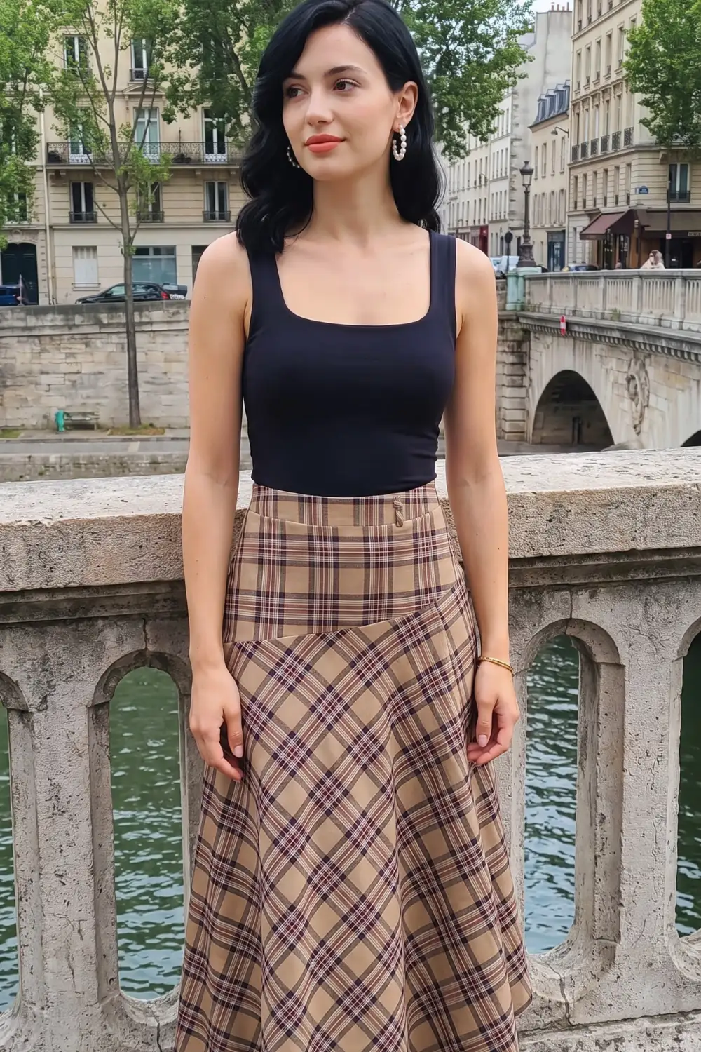 Woman in navy square neck tank top with camel brown plaid high waist midi flare skirt