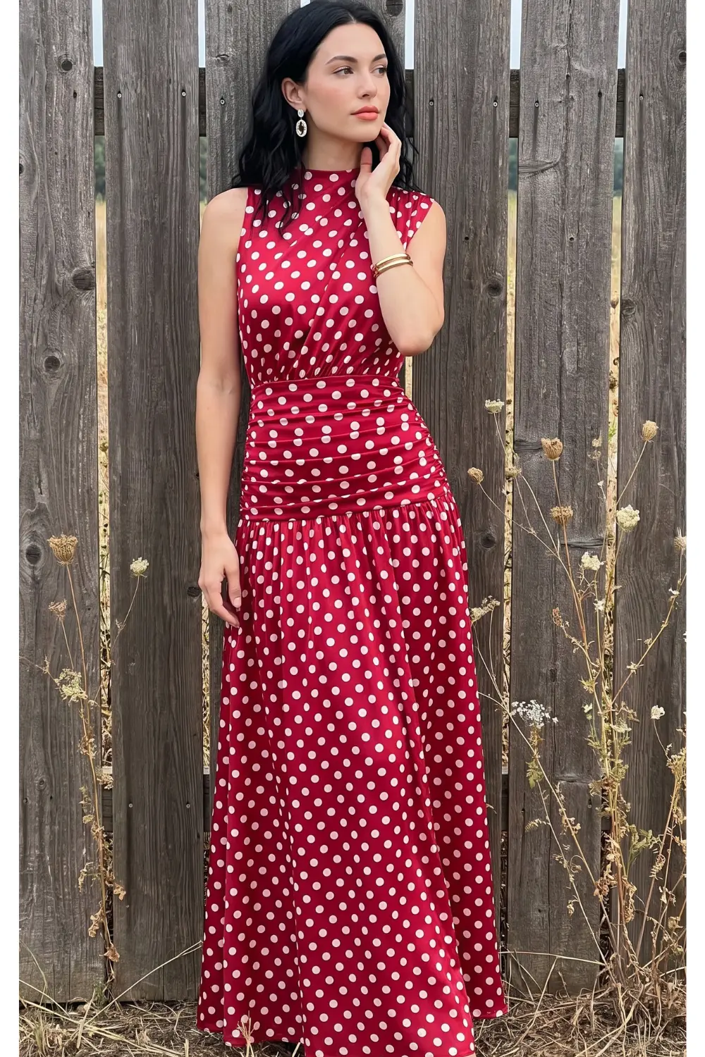 Woman in red white polka dot high neck ruched sleeveless maxi dress