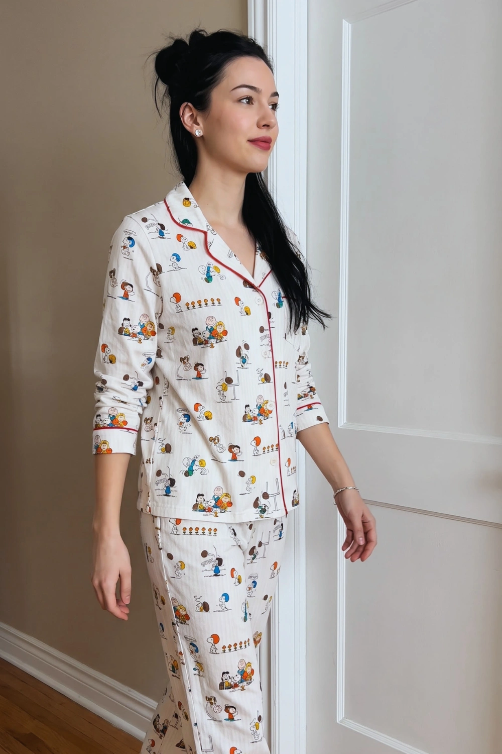 Woman in white cream Snoopy cartoon print long sleeve button down shirt and wide leg pants pajama set