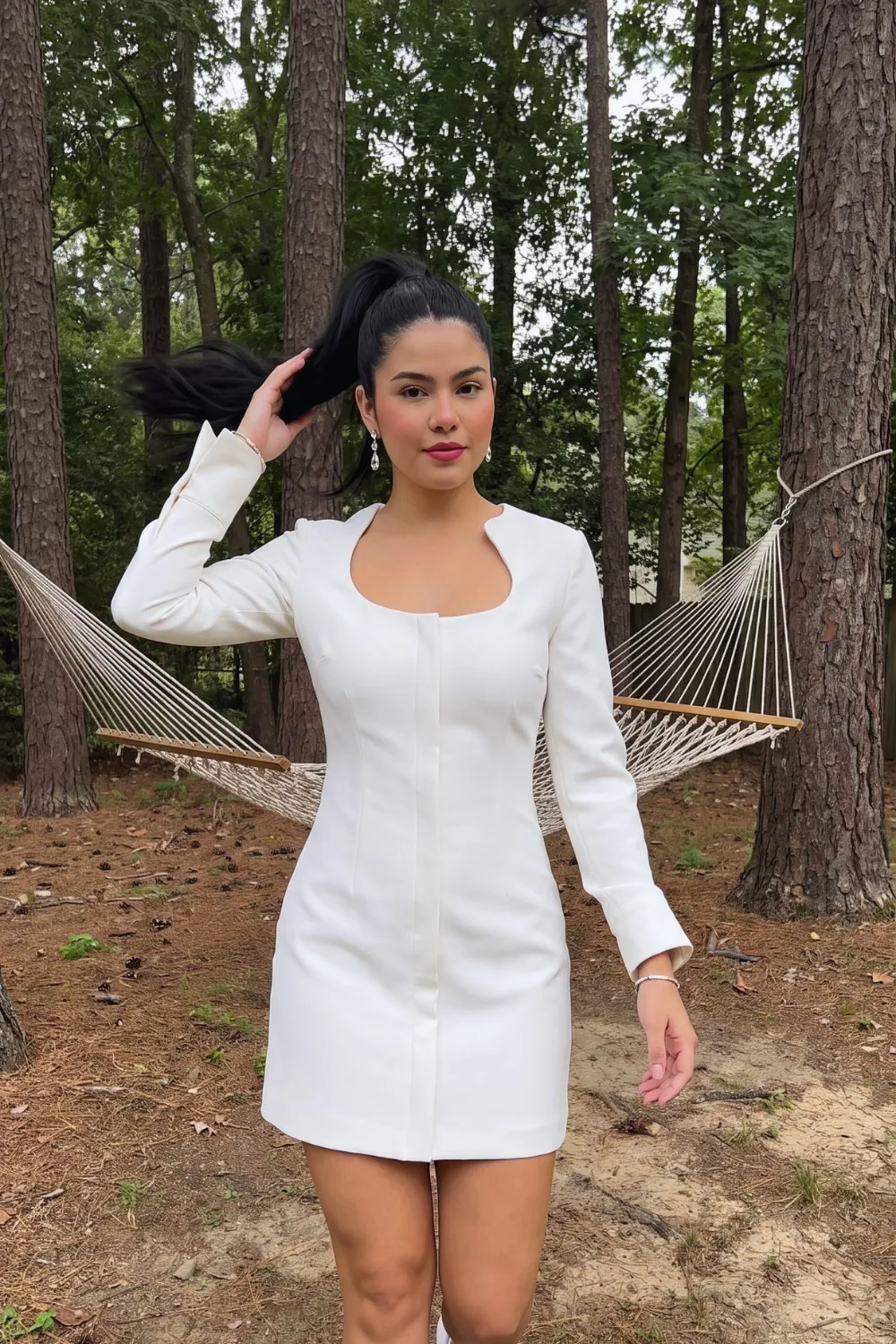 Woman in white structured scoop neck long sleeve mini dress